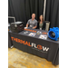 A young man and woman sitting behind a booth table for Thermaflow Technologies. 