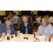 three women sitting at a table smiling at the camera