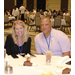 A woman and a man sitting at a table smiling at the camera