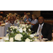 Two gentlemen sit a banquet table