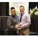 A women and gentleman both holding an award. 