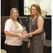 Two women holding an award