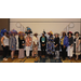 A group of women wearing large decorated  hats