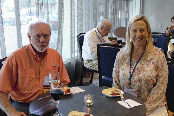 A man and a woman sitting at a cafe table