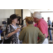 a group of people standing and speaking to each other