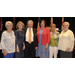 A group of people standing together and posing for the camera