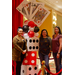 Three woman stand together and smile next to the giant dice and playing card decor.