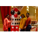 Two women and Shaundra Clark stand together and smile next to the giant dice and playing card decor.