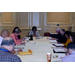 Ivory Mathews sits at the head of a table of men and women.