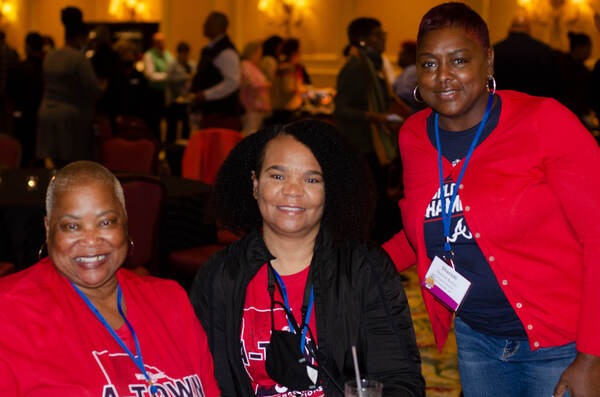 Alfrieda Thomas, Director of Resident Services (Newnan, GA); Sandra Strozier, PhD & President/CEO (Newnan, GA); Shanicki Burton, ED (MCDonough, GA) gather together and smile.