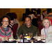 Ashiya Hawkins, ED (MS Region V), Sharonda Blaylock, Accounts Payable (MS Region V), Joy Carey, HCV Specialist/EHV Coordinator (MS Region V) sit together and smile as they share a meal.