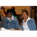 A man and a woman sit at the dinner table together.