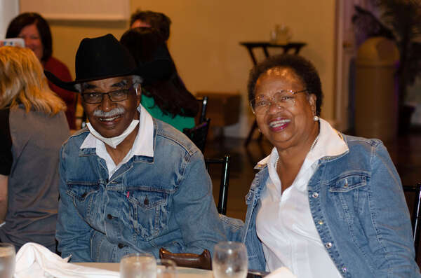 A man and a woman sit at the dinner table together.