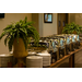 Stacks of plates on the table with catering dishes.