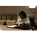 Executive Director Doris Richardson sitting at table writing