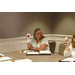 Executive Director Marie Harris sitting at a table holding a cup