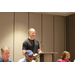 Executive Director Tom Wachs standing on stage smiling