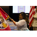 Executive Director Maria Catron holding a flag