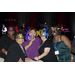 Four women wearing masks and smiling next to each other