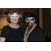 Four women wearing masks and smiling next to each other