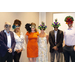 Six people wearing masks and smiling next to each other