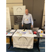 A man standing behind the booth for the Housing Agency Retirement Trust. 