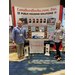 A man and woman standing on either side of a large booth for Landlordlocks.com Inc.
