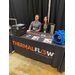 A young man and woman sitting behind a booth table for Thermaflow Technologies.