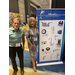 A man and a woman posing next to a sign for Marlin Manufacturing. 