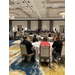 The view of the entire conference room listening to a speaker.