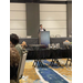 A woman speaks behind a podium to a room full of people. 