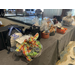 A table full of giftwrapped baskets up for auction. 