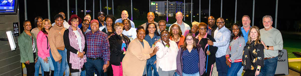 A large group of individuals standing together for a photo.