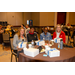 Four individuals sitting at a dinner table.