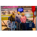 Three men standing in front of a race car track back drop.