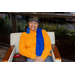 A woman sitting down wearing orange and blue.