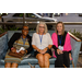 Three women sitting on a couch.