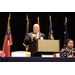 A man standing by a podium. 