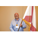 A man holding the Alabama state flag.