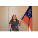 A woman holding the Georgia state flag.