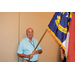A man holding the North Carolina State flag.