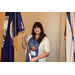 A woman holding the Virginia state flag.