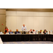  Man with glasses in a light blue shirt standing at the podium for the Executive Committee meeting. 