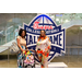  Two ladies with a baby in a stroller at the Executive Committee dinner in front of a Chick-fil-a sponsored College Football Hall of Fame sign. 