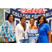  Lineup of four women at the Executive Committee dinner in front of a Chick-fil-a sponsored College Football Hall of Fame sign. 