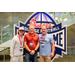  Lineup of three men at the Executive Committee dinner in front of a Chick-fil-a sponsored College Football Hall of Fame sign. 