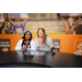  Two women sitting at the broadcasting ESPN College Gameday news table. 