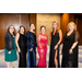  Six women in dresses smile for a picture outside the Tim Lindgreg Centennial Ballroom. 