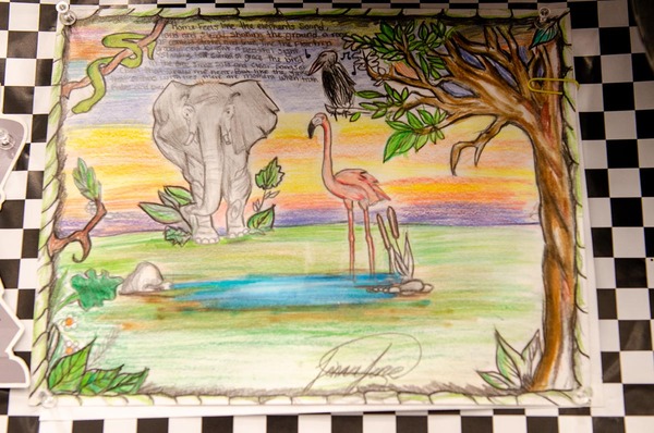  At the top of the poster, there is a poem that states: Home feels like the elephants sound, loud and steady, shaking the ground, a roar of comfort strong and true. Then the flamingo, graceful and bright, a beautiful sight. Standing on the symbol of grace, the bird in the tree sings soft and clear, songs of cheer that draw me near. But like the snake that slithers with lies, there are moments when truth fades and dies.