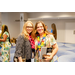  Two woman leaning in for a photo while wearing their colorful leis. 